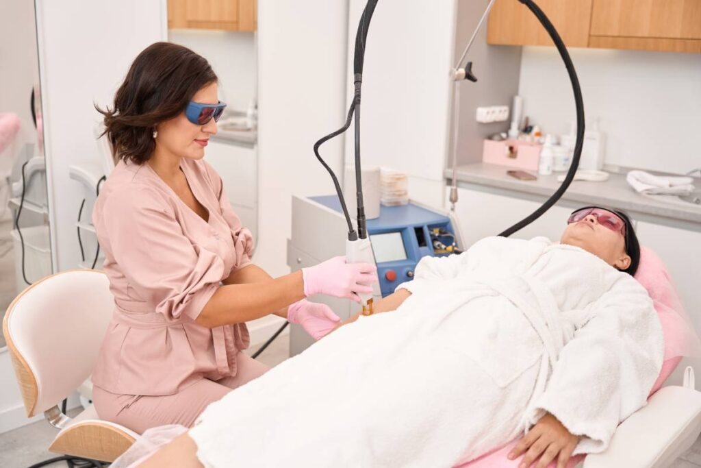 Laser hair removal procedure for hands in a cosmetology clinic