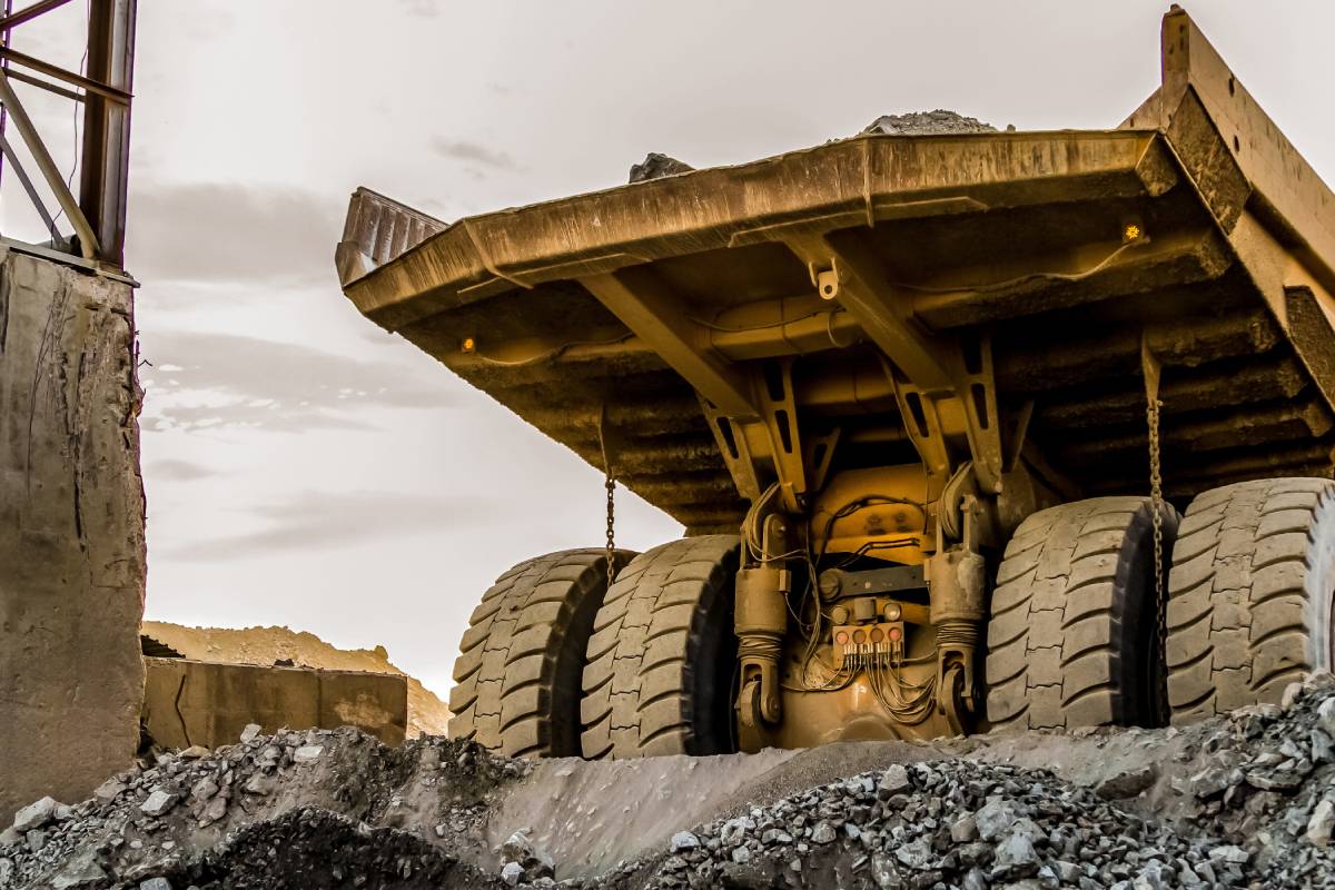 Open pit platinum mining industry with a machine on background of the sky